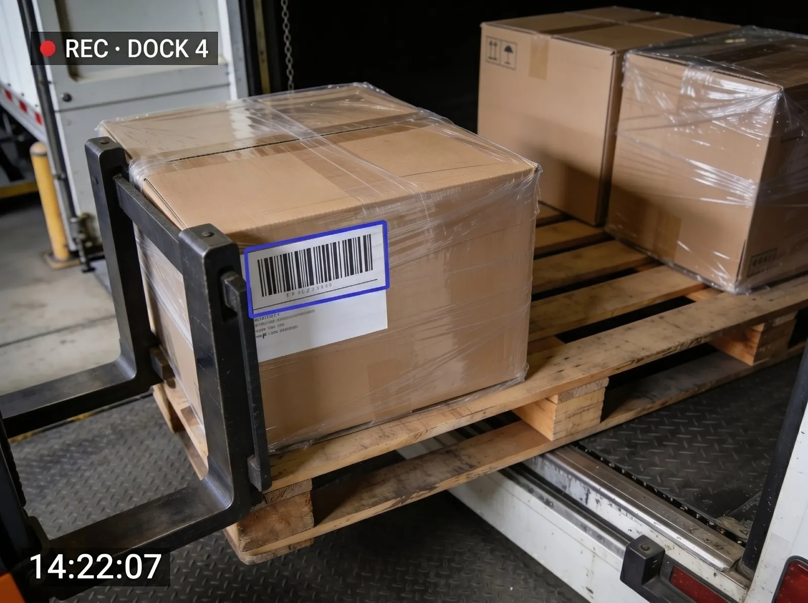 Captured dock frame: a shrink-wrapped pallet with its shipping label detected at Dock 4